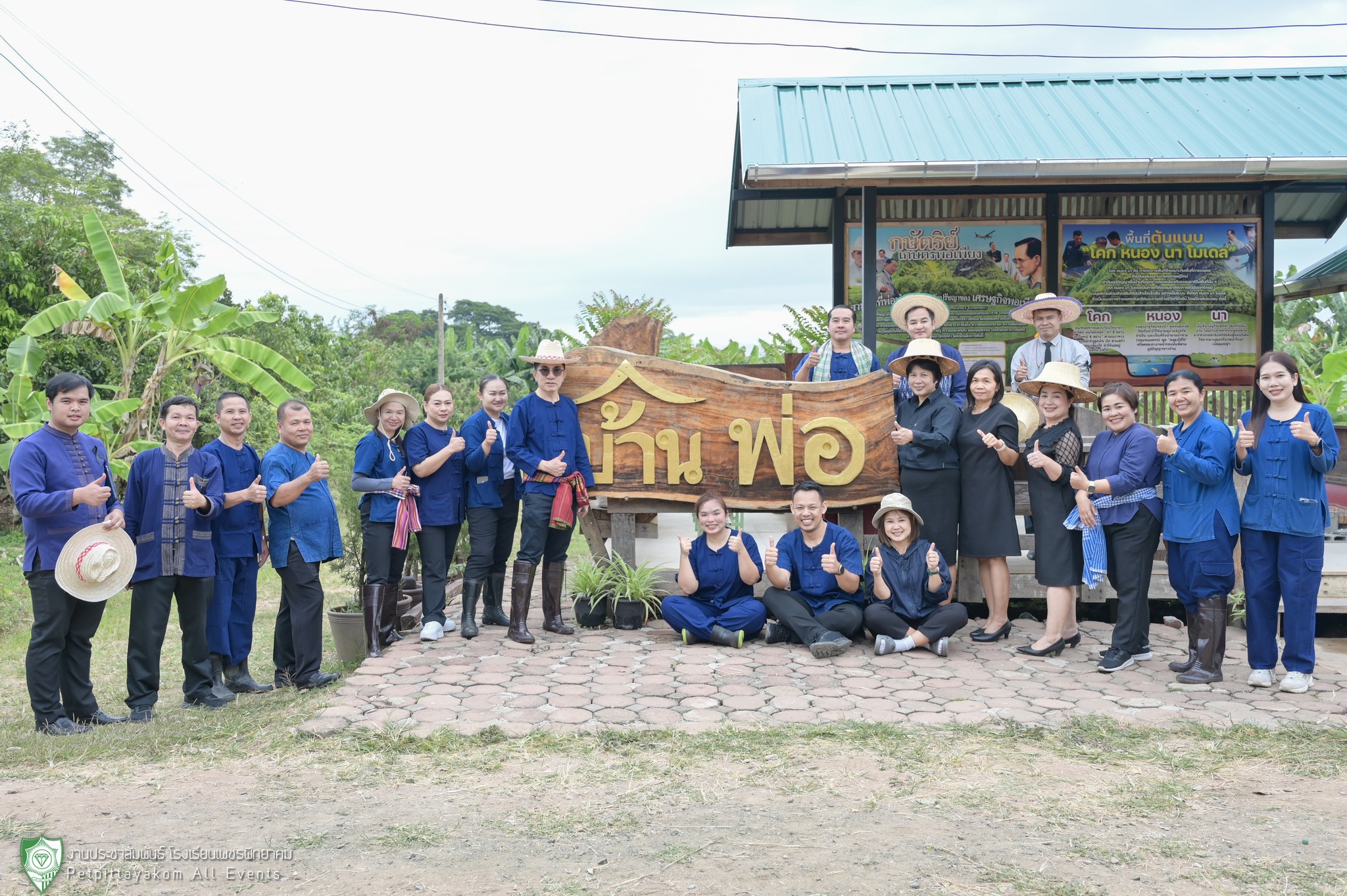 คณะครูและนักเรียนร่วมถ่ายภาพหน้าป้ายบ้านพ่อ